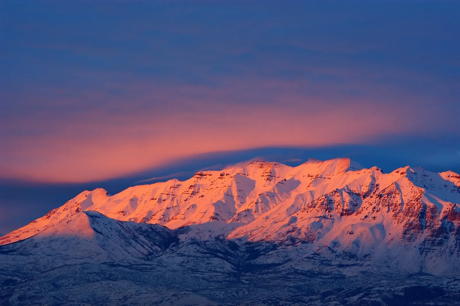 Mount Timpanogos glowing pink at sunset above Utah Valley