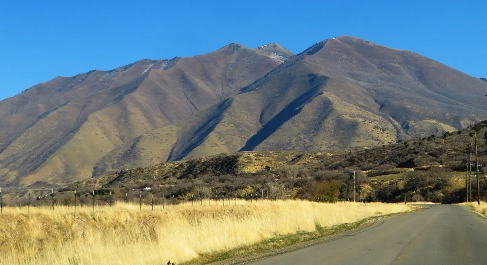 Golden fields and mountains in rural Utah County near Spanish Fork Canyon